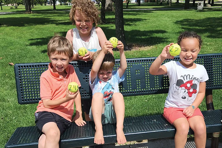 Kids smiling with tennis balls
