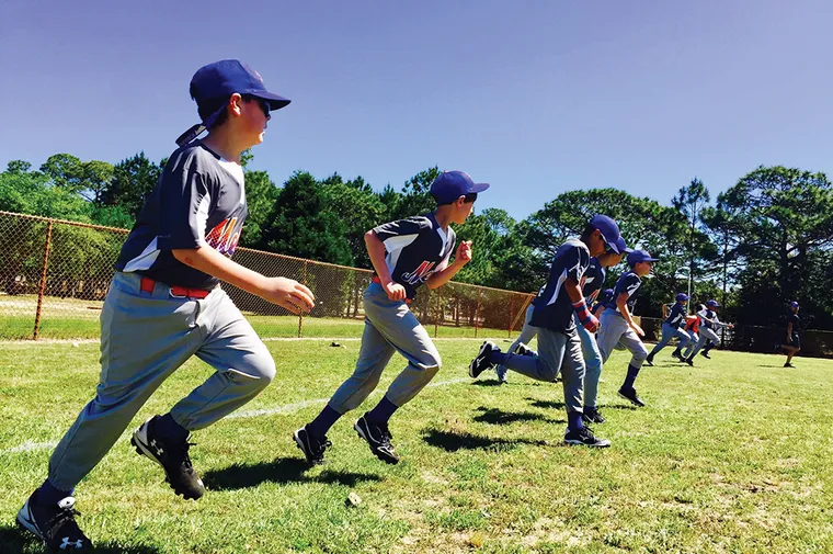 Youth baseball team warming up for a g