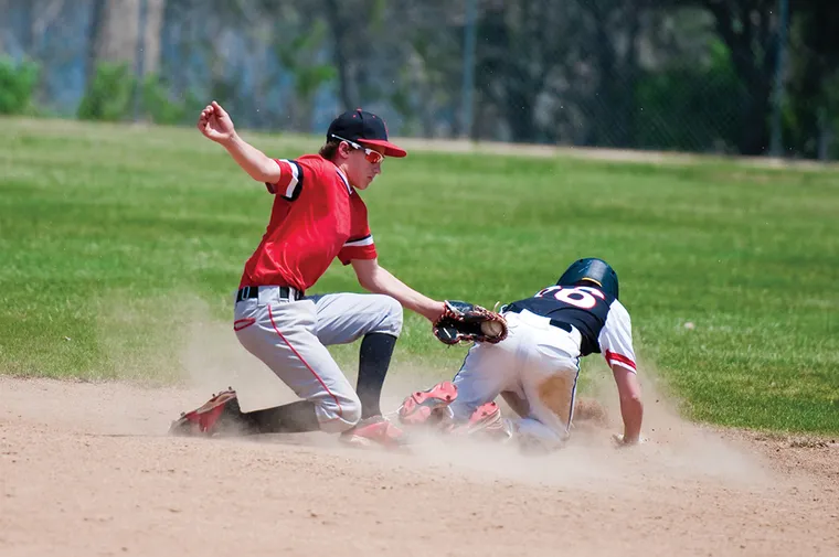 Baseball player sliding into the base